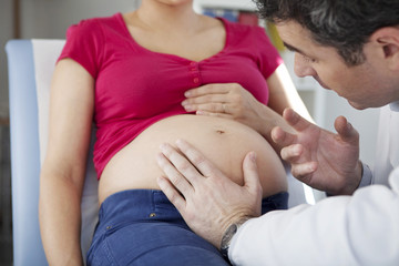 Fototapeta premium Abdomen palpation pregnant woman