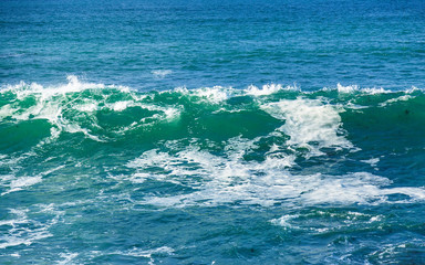 Fototapeta na wymiar Seascape with rocks, foam and spray of the waves