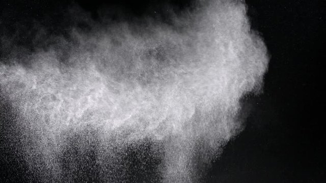 Spurt of particles from side filling frame studio shot
