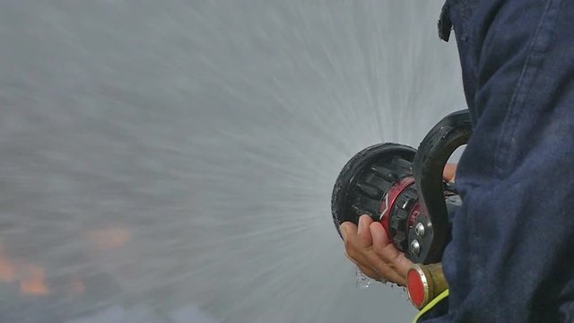 firefighter control the fire to calm down
