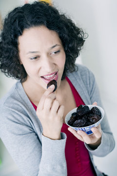 Woman Eating Prunes