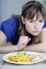 Obraz na płótnie Canvas Woman looking her meal