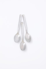 Silver three spoons on a white background