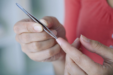 Woman removing a splinter