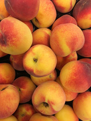 Top view of ripe peaches in pile