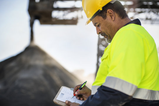 Worker wearing protective clothing standing at quarry