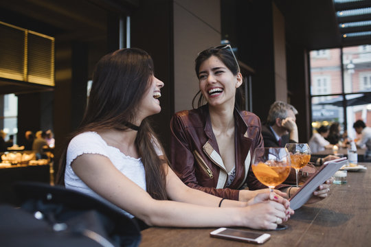 Two happy young women in a bar