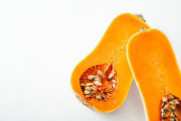 Butternut squash halved on white background with copy space. Organic food concept.