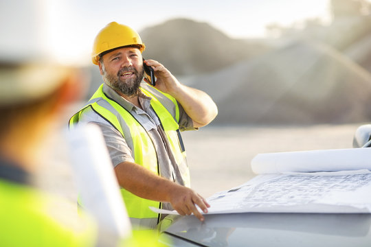 Quarry worker on site talking on the phone
