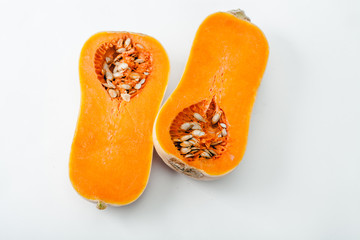 Butternut squash halved on white background with copy space. Organic food concept.