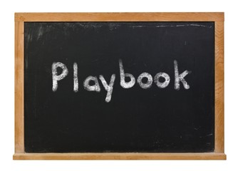 Playbook written in white chalk on a black chalkboard isolated on white