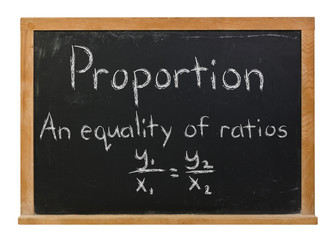 Proportion formula written in white chalk on a black chalkboard isolated on white