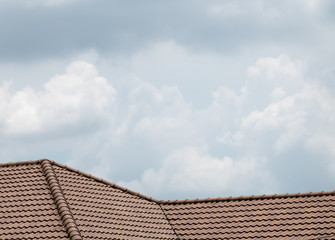 brown peaked roof. a roof top with red tiles.