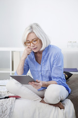 Senior woman using tablet computer