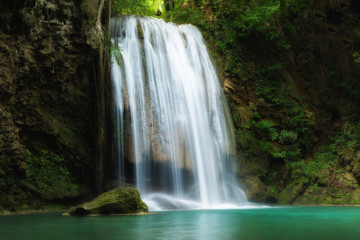 Fototapeta na wymiar Erawan Waterfall is a beautiful waterfall in spring forest in Kanchanaburi province, Thailand.