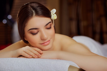 Obraz na płótnie Canvas Portrait of a beautiful woman close-up lying down in a spa salon.