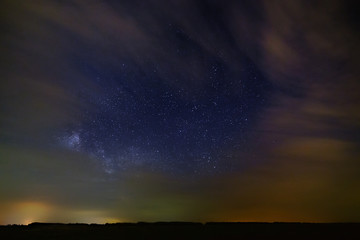 Night starry sky with clouds.
