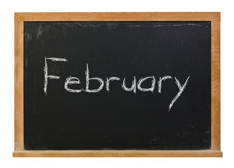 Obraz premium February written in white chalk on a black chalkboard isolated on white