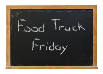 Obraz premium Food Truck Friday written in white chalk on a black chalkboard isolated on white