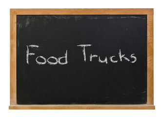 Food Trucks written in white chalk on a black chalkboard isolated on white