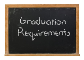 Graduation requirements written in white chalk on a black chalkboard isolated on white