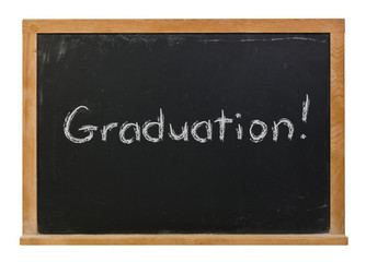 Fototapeta premium Graduation written in white chalk on a black chalkboard isolated on white
