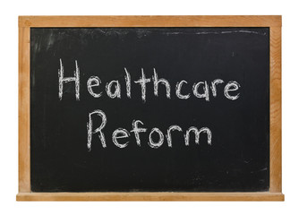 Healthcare reform written in white chalk on a black chalkboard isolated on white
