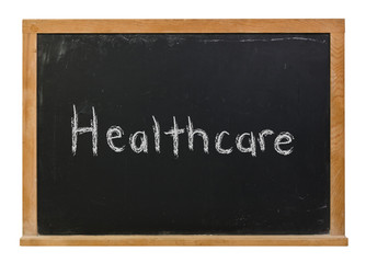 Obraz premium Healthcare written in white chalk on a black chalkboard isolated on white 