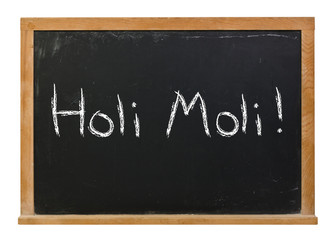 Fototapeta premium Holi Moli written in white chalk on a black chalkboard isolated on white