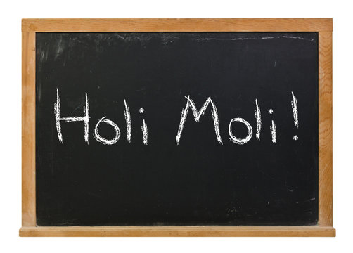 Holi Moli written in white chalk on a black chalkboard isolated on white