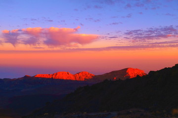 Sunset behind a volcano in a mountain scenery