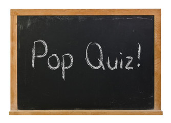 Fototapeta premium Pop quiz written in white chalk on a black chalkboard isolated on white 