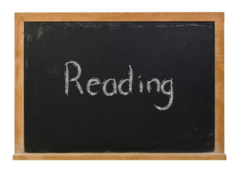 Reading written in white chalk on a black chalkboard isolated on white
