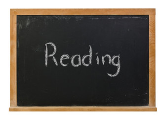 Fototapeta premium Reading written in white chalk on a black chalkboard isolated on white 
