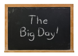 The Big Day written in white chalk on a black chalkboard isolated on white