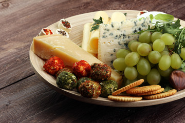 Cheese platter with different cheese and grapes