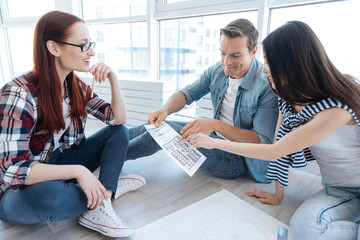 Hard working professional architects discussing a drawing