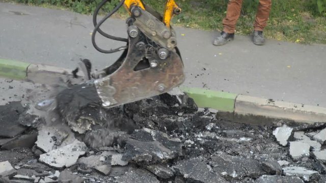 Repair Section Of The Road Surface. Hydraulic Hammer Breaker On Excavator Destroying Asphalt Layer Near The Curb Stone