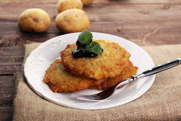 Potato pancake with cow berry sauce, selective focus © beats_