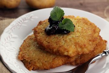 Potato pancake with cow berry sauce, selective focus