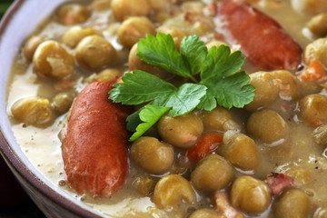 Light summer green pea cream soup in bowl