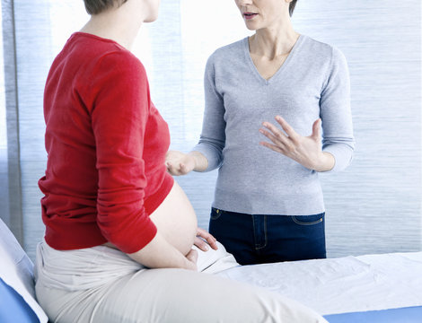 Pregnant woman and doctor talking