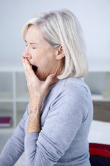 Senior woman yawning