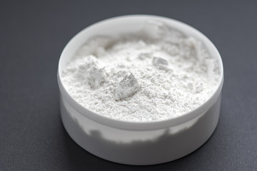 White box with white powder, black background