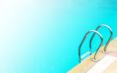 Stainless ladder of swimming pool. Outdoor background. Copy space with color effect. Abstract background.