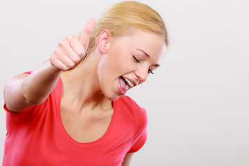 Fototapeta premium Happy woman showing thumbs up gesture