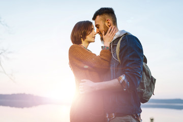 Young tourist couple at sunset sun
