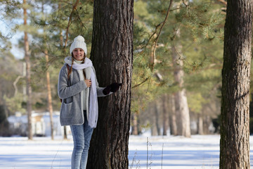 Young smiling woman on a natural background, looking at the camera, healthy lifestyle