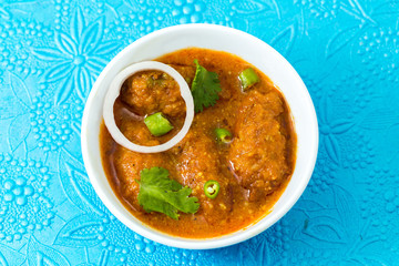 Malai Kofta or meatballs - Traditional Indian food  clicked on a blue background