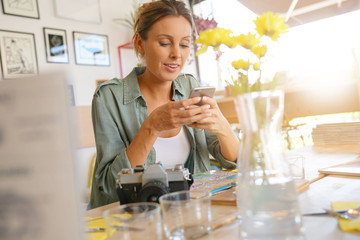 Young woman connected with smartphone at lunch time